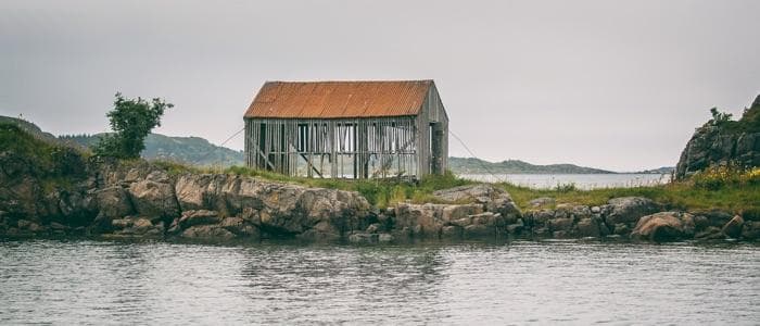  A cabin falling apart near a beach. 